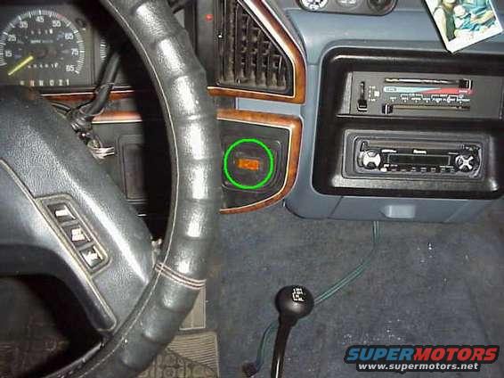 Vehicle interior with dashboard gauges, steering wheel, and gear shift