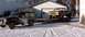 1979 Ford Bronco - A Jeep Cherokee sits in the snow next to a trailer loaded with a brown Ford pickup truck.
