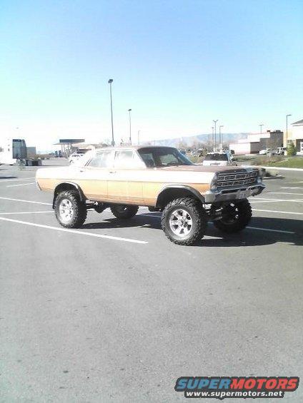 Lifted 1968 Ford sedan with large tires and two-tone paint