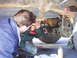 1989 Ford F-350 - Mechanics perform maintenance on the rear axle assembly of a truck, using power tools.