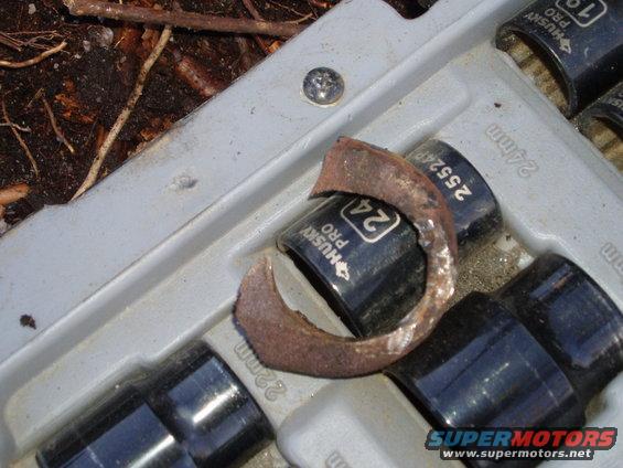 Socket set with a rusty metal ring on top of a 24mm socket. Some sockets are labeled Husky Pro