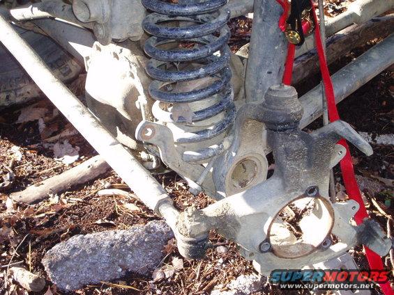 Front suspension knuckle and coil spring