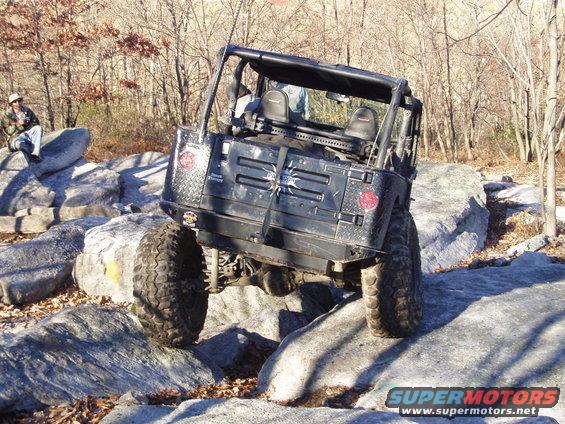 Rear view of black off-road vehicle on rocks
