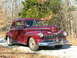 1946 Mercury Coupe - Maroon 1946 Mercury Coupe with chrome grille and trim, seen outdoors.
