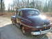 1946 Mercury Coupe - Rear view of a maroon 1946 Mercury Coupe parked on a gravel road.