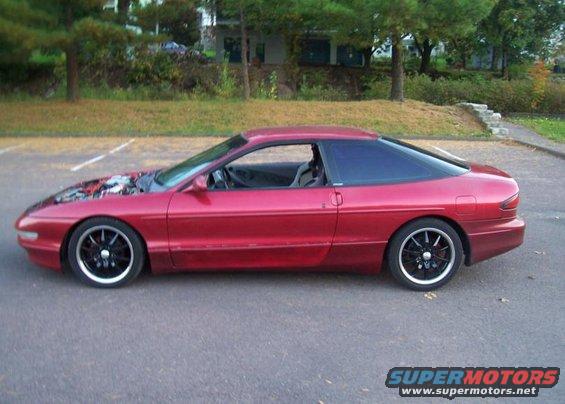 red coupe, hood up, parked outside
