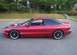1995 Ford Probe - Side view of a red coupe with its hood open, parked in a lot.