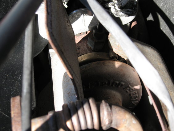 Close-up of a turbocharger housing with visible text and part numbers