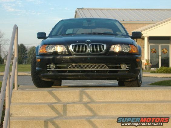 Front view of a black 2001 BMW 3 Series sedan parked on steps
