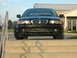 2001 BMW 3 Series - A black BMW 3 Series sedan is parked facing forward on a set of concrete steps.