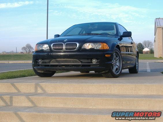Black BMW 3 Series sedan parked on concrete steps, front view
