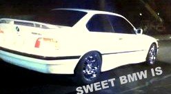White 2001 BMW 3 Series coupe, rear 3/4 view, aftermarket wheels