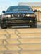 2001 BMW 3 Series - Front view of a black 2001 BMW 3 Series sedan parked on concrete steps.