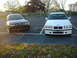 2001 BMW 3 Series - Two BMW 3 Series sedans, one black and one white, are parked in an outdoor lot.