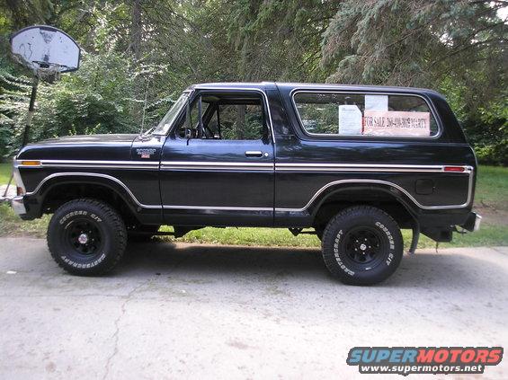 1978 Ford Bronco side profile, black paint, chrome trim, "FOR SALE" sign in rear window