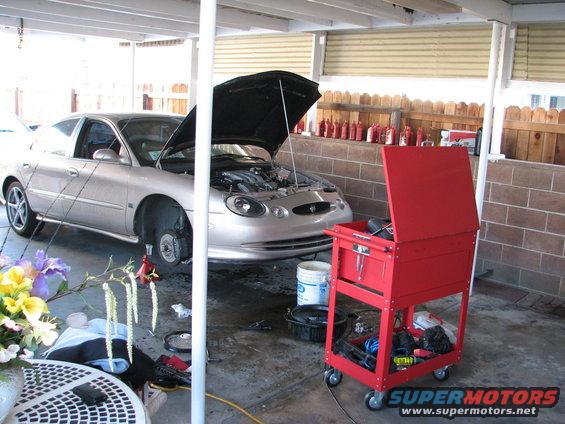 Silver 1998 Mercury Sable with hood open and front wheel removed