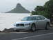 2006 Dodge Charger - A silver 2006 Dodge Charger is parked on a road next to the ocean with a distinctive island formation in the distance.