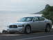2006 Dodge Charger - Silver 2006 Dodge Charger parked by the water with a scenic mountain backdrop.