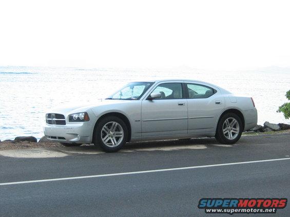 Silver 2006 Dodge Charger parked on a road next to the ocean