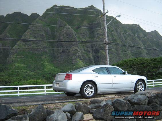 Silver 2006 Dodge Charger sedan parked on a road with mountains in the background