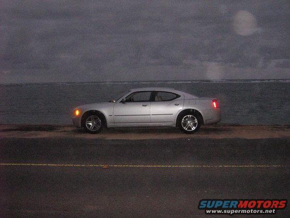 Silver 2006 Dodge Charger parked on a road next to the ocean