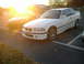 2001 BMW 3 Series - Two BMWs, a coupe and a sedan, are parked in a lot during sunset.