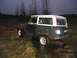 1968 Ford Bronco - 1968 Ford Bronco sits in a muddy, wet field under a dark sky.