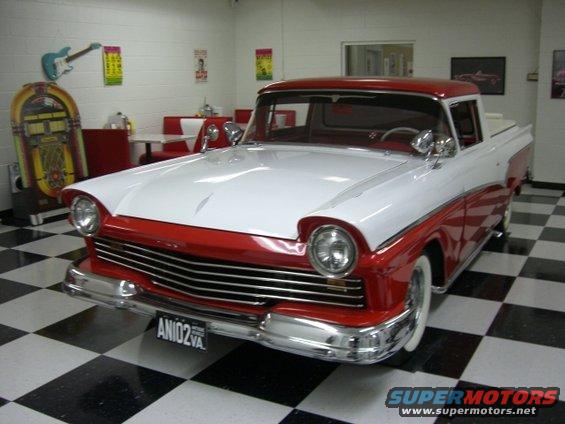 1957 Ford Ranchero, two-tone red and white, parked indoors on a checkered floor