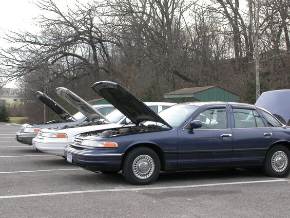 Dark blue 2001 Ford Crown Victoria sedan, side view, hood open