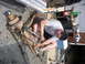 1996 Ford F-250 - A mechanic works on a truck's suspension system, which has been removed from the vehicle.