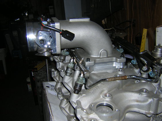 Throttle body and fuel injectors on an engine block