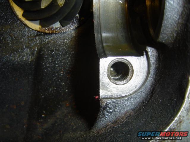 Close-up of engine part with visible gears and oil