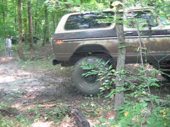 Brown and tan Ford Bronco, rear view, off-road tires