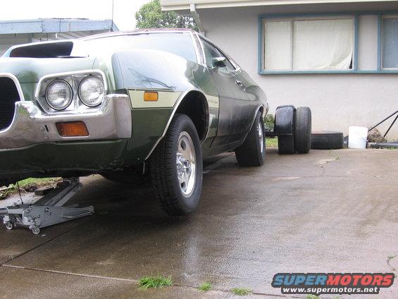 1972 Ford Ranchero with hood scoop, jacked up on the front, two spare tires stacked behind the rear wheel