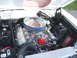 1966 Ford Fairlane - Custom V8 engine in an engine bay, aftermarket parts and visible wiring. Supermotors logo is present.