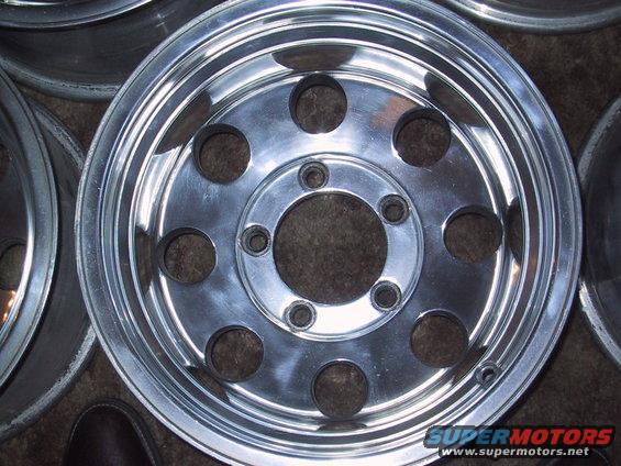 close-up of a shiny aluminum wheel with multiple lug nut holes