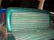 1979 Ford Bronco - Interior view of a vehicle's green striped seat with teal trim and a green seatbelt.