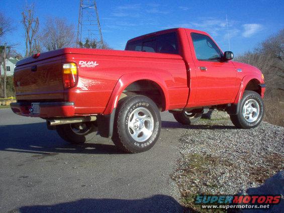 Red 2001 Mazda B3000 pickup truck, rear 3/4 view