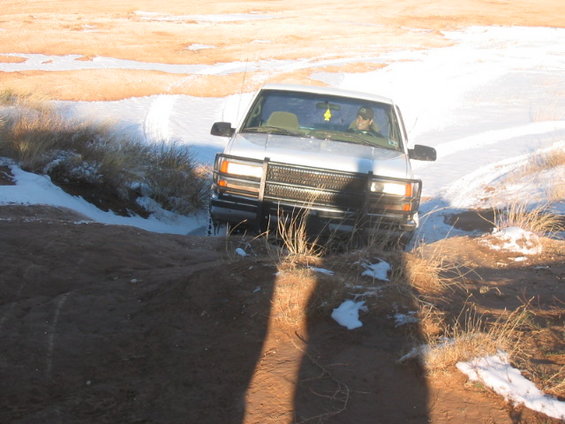 2003 Ford Ranger driving on a dirt path with snow patches