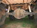 1992 Ford Mustang - Underside view of a vehicle's rear axle, differential, leaf springs, and shock absorbers.