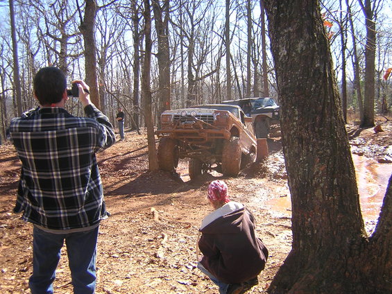 Muddy 1979 Ford Bronco off-roading, 3q-front view