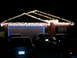 1997 Ford Probe - Multiple vehicles are parked in front of a house adorned with festive holiday lights.