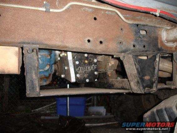 Vehicle undercarriage showing a black fuel pump assembly mounted to the frame