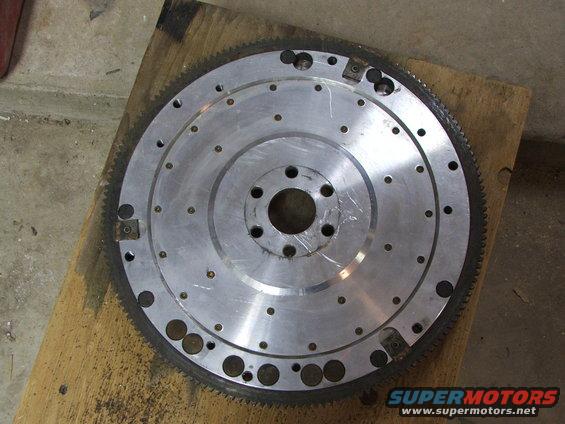 Aluminum flywheel with gear teeth on outer edge