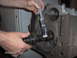 1978 Ford Bronco - A mechanic applies lubricant to a camshaft before installing it into an engine block.