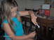 1978 Ford Bronco - Girl works on a water pump part with a tool, with a "Water Pump" box in the background.