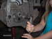 1978 Ford Bronco - A person works on an engine block, with a date stamp indicating the photo was taken in 2005.