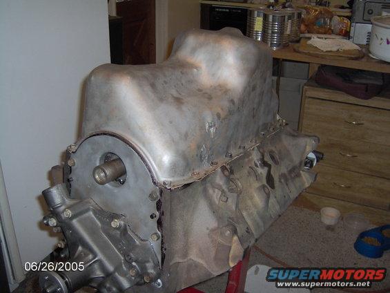 Engine block with oil pan attached, viewed from the side