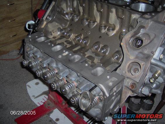 Engine block with valves and springs on red stand