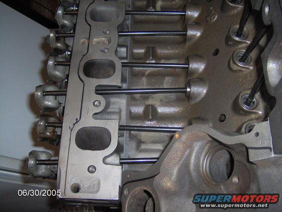 Engine block with intake manifold gasket and pushrods visible